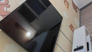 A room with a large flat-screen TV mounted on the wall, a white air conditioning unit, and bear-themed wall decals. - Sleep Taipei Hotel Nan-Ya Branch (New Taipei City)