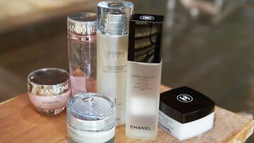 A collection of skincare products on a wooden surface.