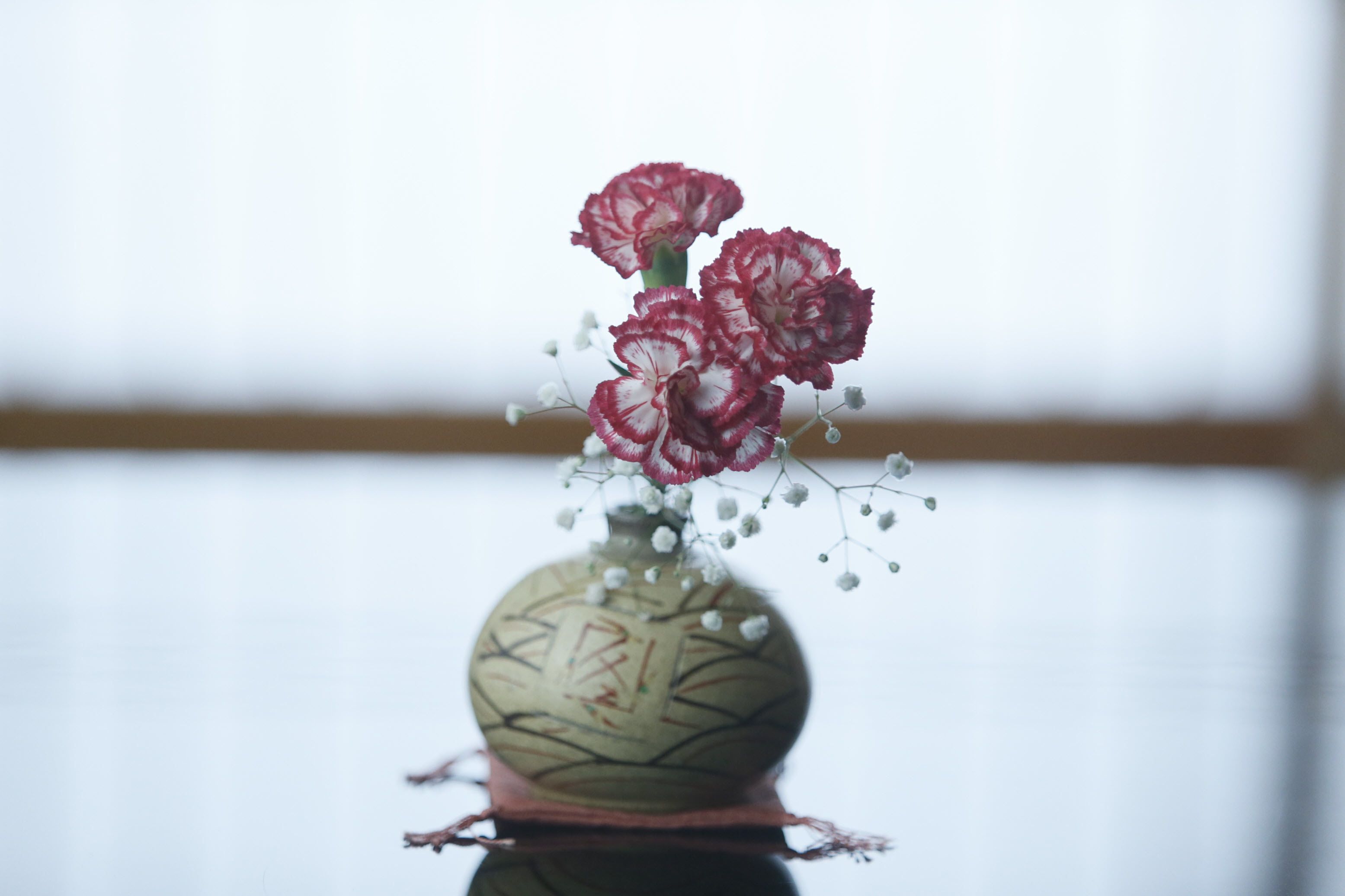 A vase with flowers and decorative elements.