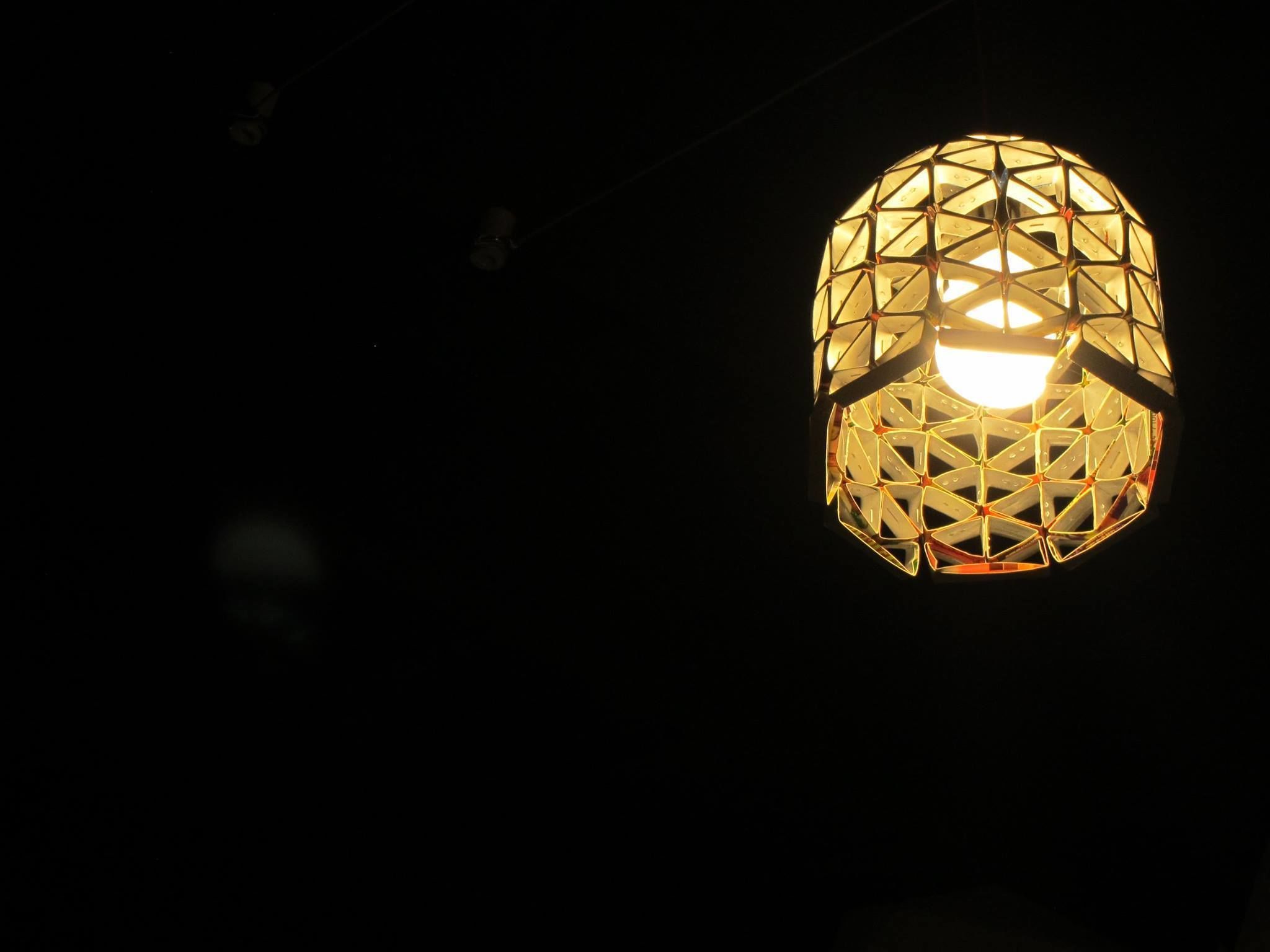 A spherical light fixture with a geometric pattern.