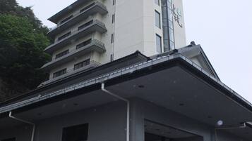 A multi-story building with a prominent sign on the top.
