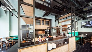 A modern breakfast bar with a variety of food items and a coffee station. - Maison Schiller (Munich)