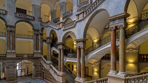 A grand interior with multiple arches, marble columns, and ornate staircases. - Maison Schiller (Munich)