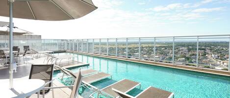 Outdoor pool, open 10:00 AM to 6:00 PM, pool umbrellas, sun loungers