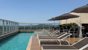 Outdoor pool, open 10:00 AM to 6:00 PM, pool umbrellas, pool loungers