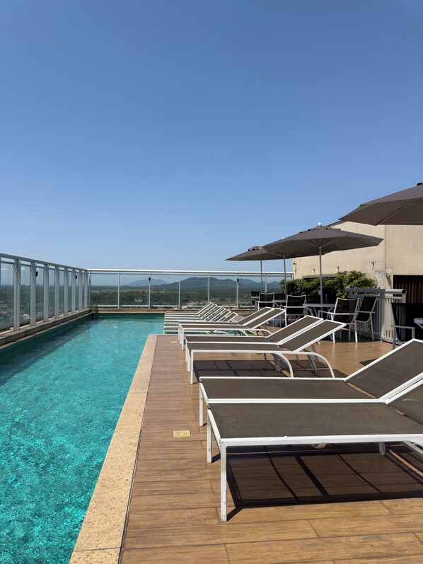 Outdoor pool, open 10:00 AM to 6:00 PM, pool umbrellas, pool loungers