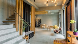 A modern interior with a staircase, wooden accents, and a dining area. - Sunrise Bed and Breakfast (Dongshan)