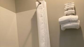 A bathroom with a bathtub, toilet, and a shower curtain.