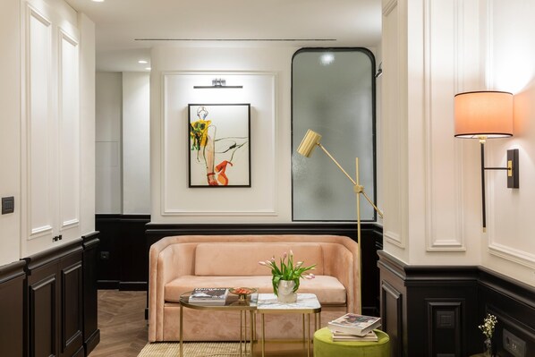 A modern living room with a beige sofa, a small coffee table, and a floor lamp.