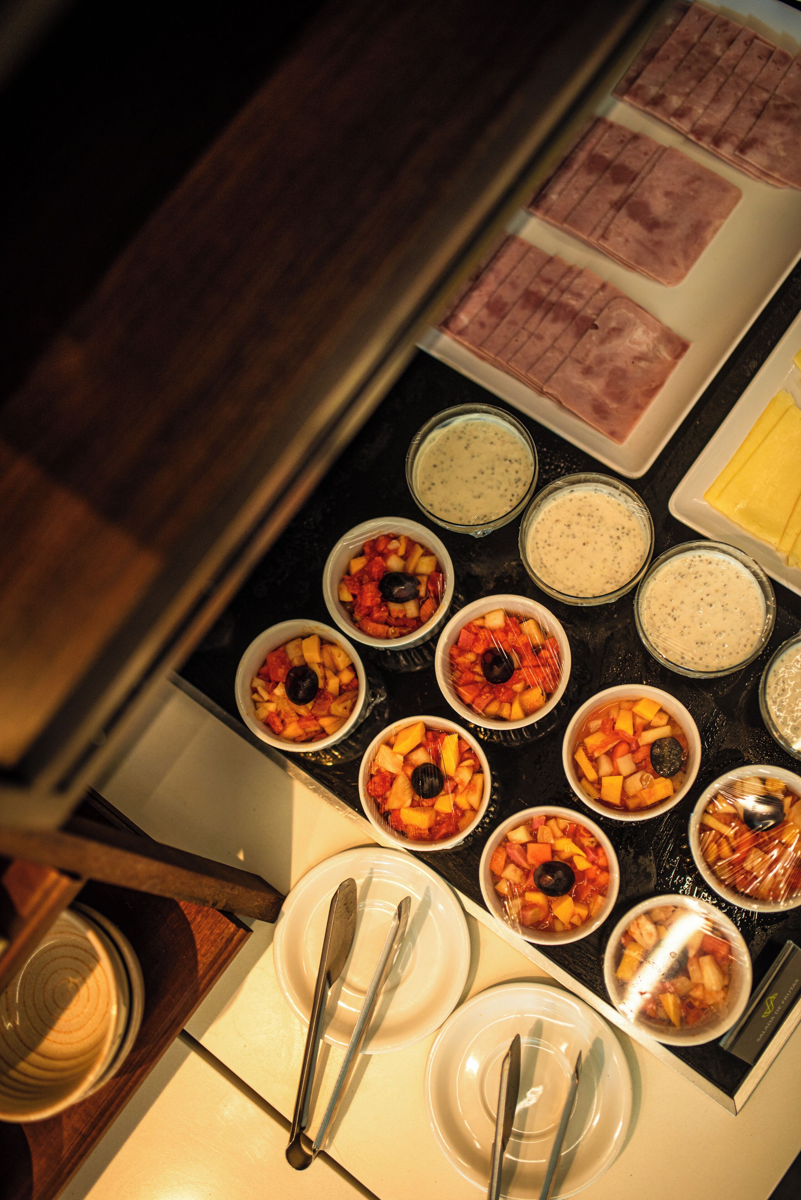 A buffet with various dishes and condiments.