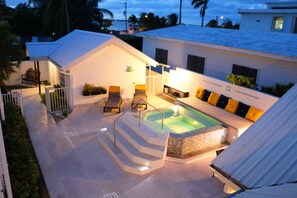 A rooftop pool area with a hot tub, lounge chairs, and a staircase leading to the pool. - Villa Boscardi (Belize City)