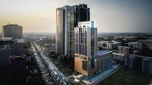 A high-rise building with a prominent sign for 'Best Western PLUS' hotel.