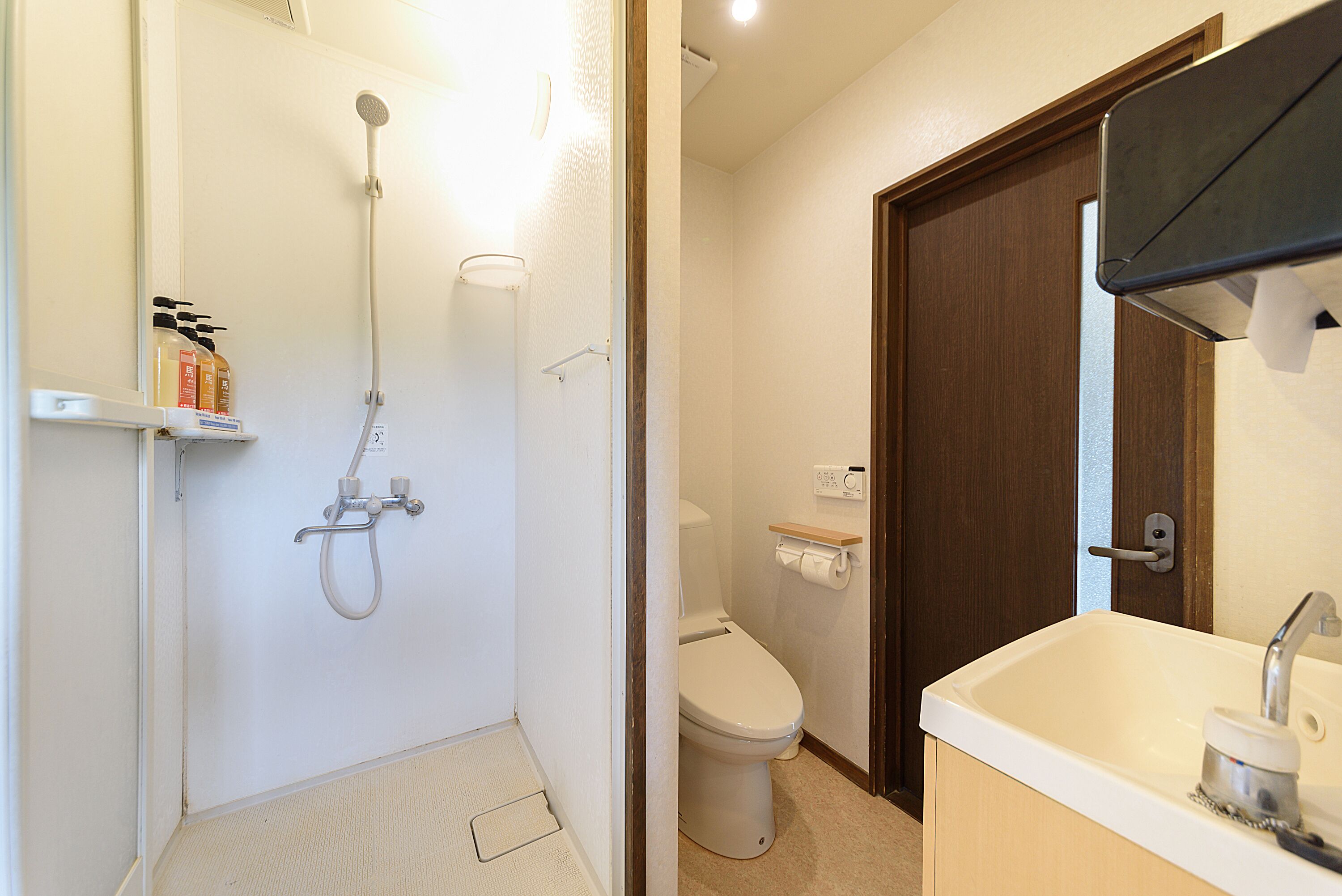 A bathroom with a shower, toilet, and sink.