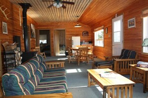 Standard Cabin, 4 Bedrooms, River View | Living area | Fireplace - Kaska Goose Lodge (Gillam)