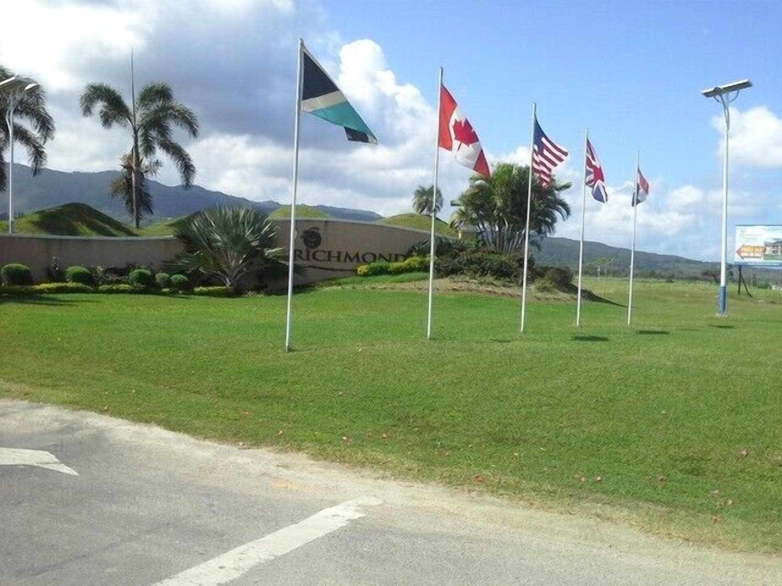 A grassy area with multiple flags, including the Canadian and American flags, and a sign that reads "RICHMOND".