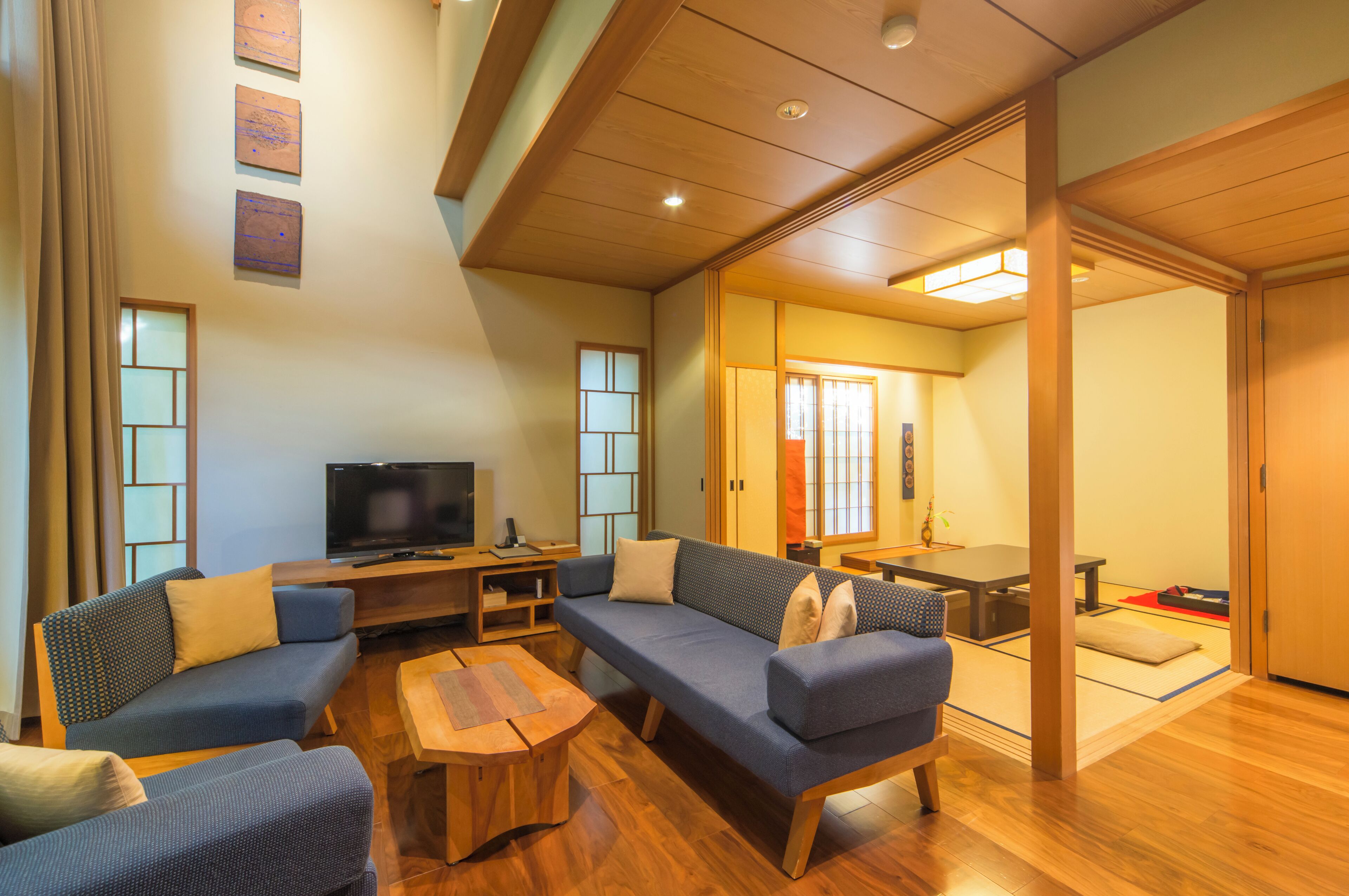 A modern living room with a sofa set, a coffee table, and a TV.