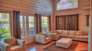 Deluxe Cottage | Living area | 42-inch flat-screen TV with satellite channels, TV, fireplace