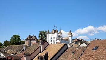 A historic building with multiple towers and a steeply pitched roof.