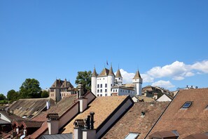 A historic building with multiple towers and a steeply pitched roof.