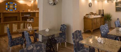A cozy dining area with wooden furniture and blue patterned chairs.