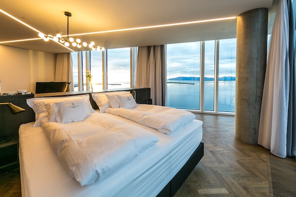 Luxury Suite (Large Corner) | Living area | 50-inch flat-screen TV with satellite channels, TV, iPad