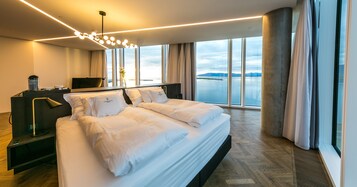 Luxury Suite (Large Corner) | Living area | 50-inch flat-screen TV with satellite channels, TV, iPad