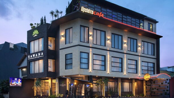 A multi-story hotel with a modern design, featuring a prominent 'Upslair's Cafe' sign and a 'Sawana Suites' sign. - Sawana Suites (Jakarta)