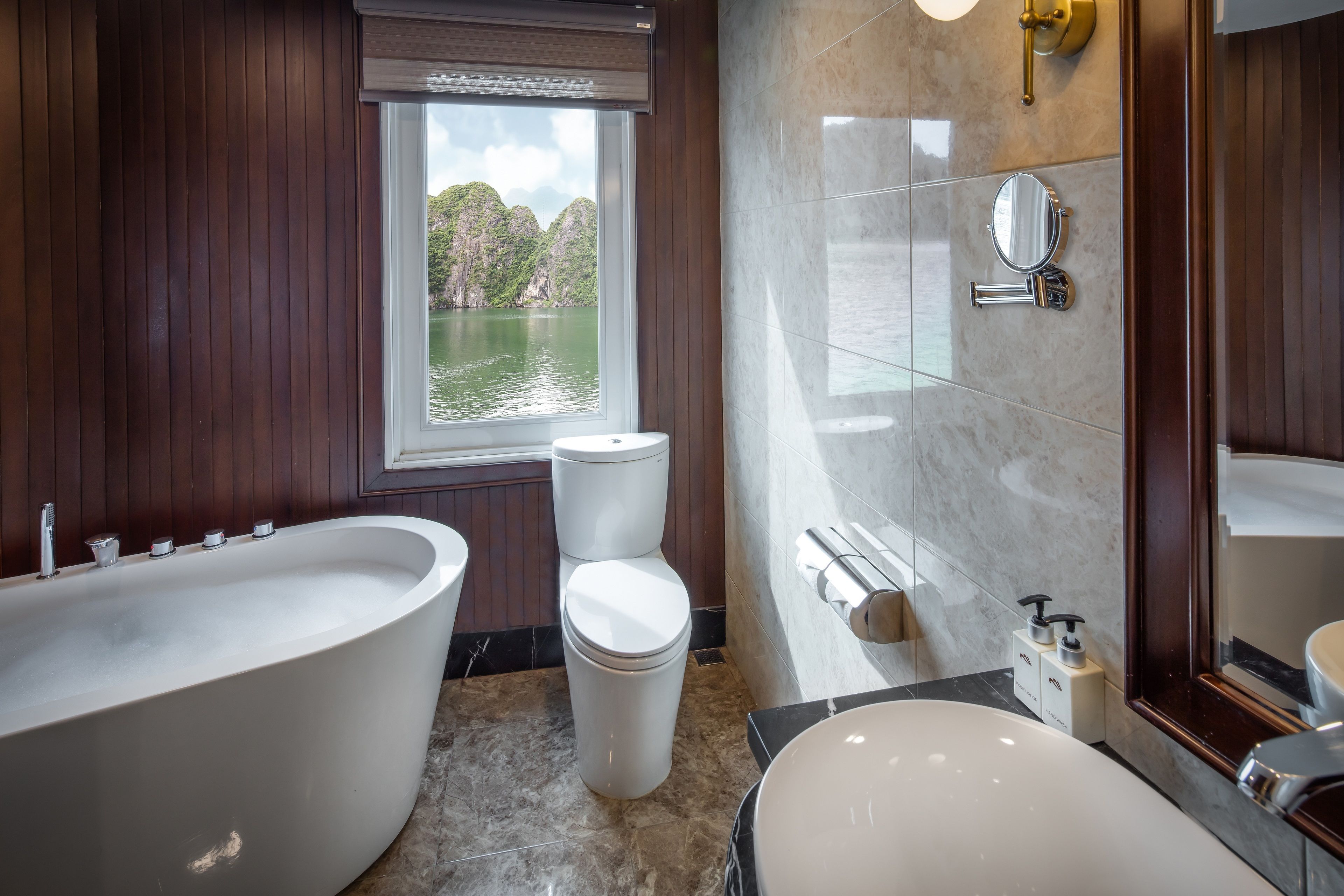 A modern bathroom with a freestanding bathtub, a toilet, and a sink.