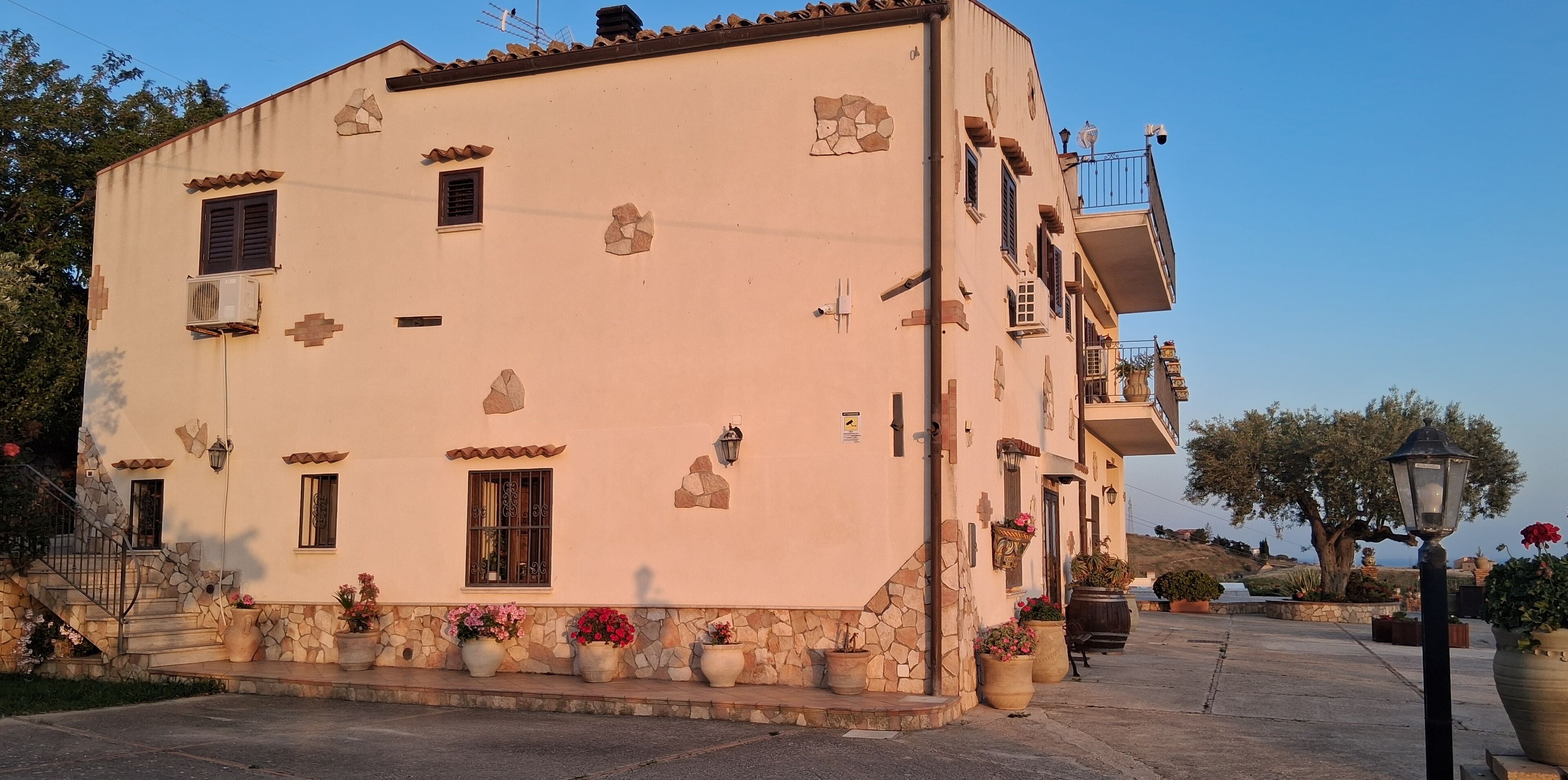 A building with a stone facade, multiple windows, and a balcony.