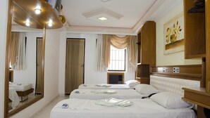 A hotel room with two beds, a large mirror, a painting, and a window with curtains. - Omega Palace Hotel (São Paulo)