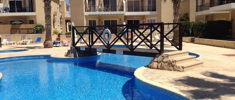 Outdoor pool, open 8:00 AM to 8:00 PM, pool umbrellas, pool loungers