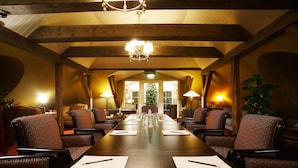 A conference room with a long table, multiple chairs, and a chandelier. - Ekesparre Boutique Hotel (Kuressaare)