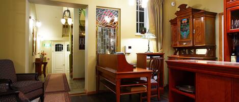 A room with a wooden coffee table, a sofa, a dining table, and a cabinet.