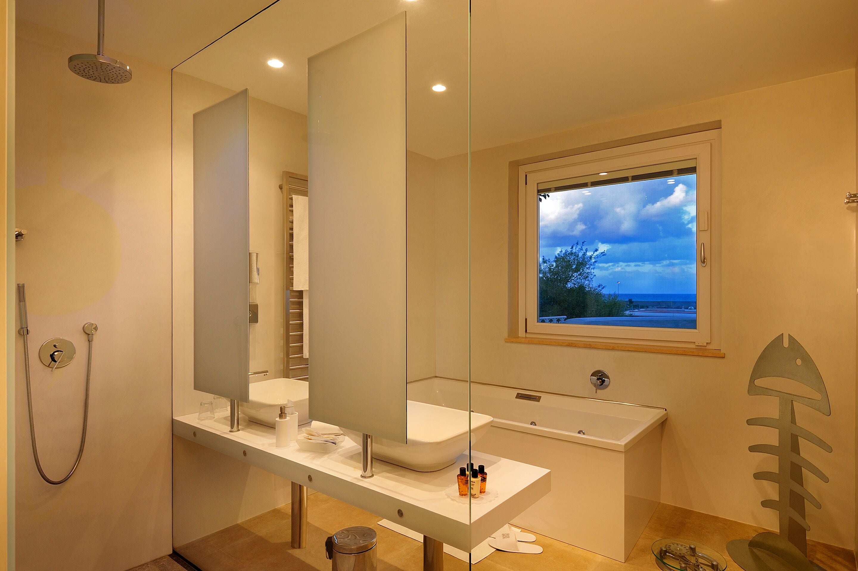 A modern bathroom with a large mirror, a bathtub, and a shower.