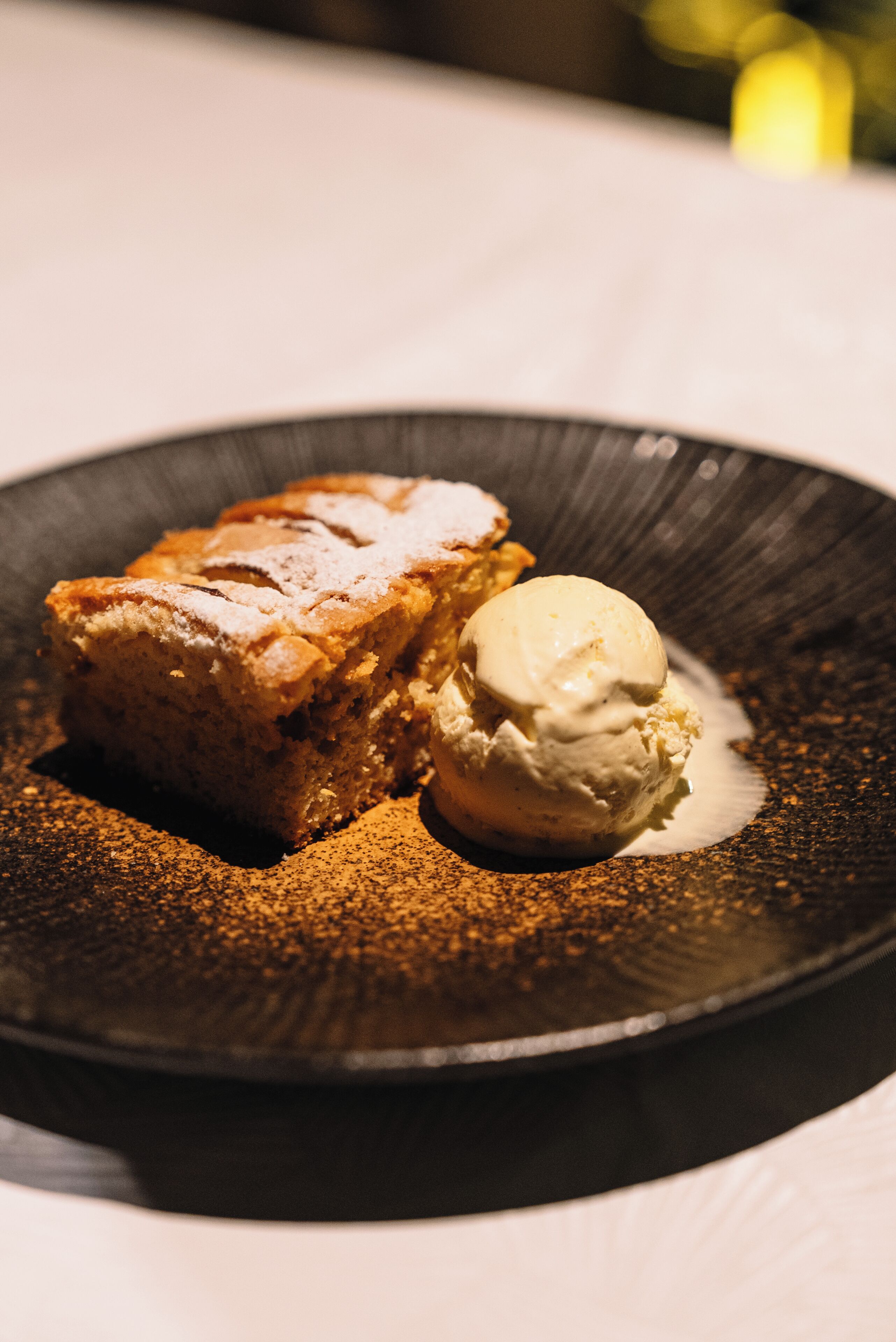 A dessert with a scoop of ice cream on a plate.