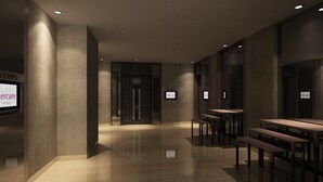 A modern hotel lobby with a reception desk, seating area, and meeting rooms. - Mercure Jakarta Cikini (Jakarta)
