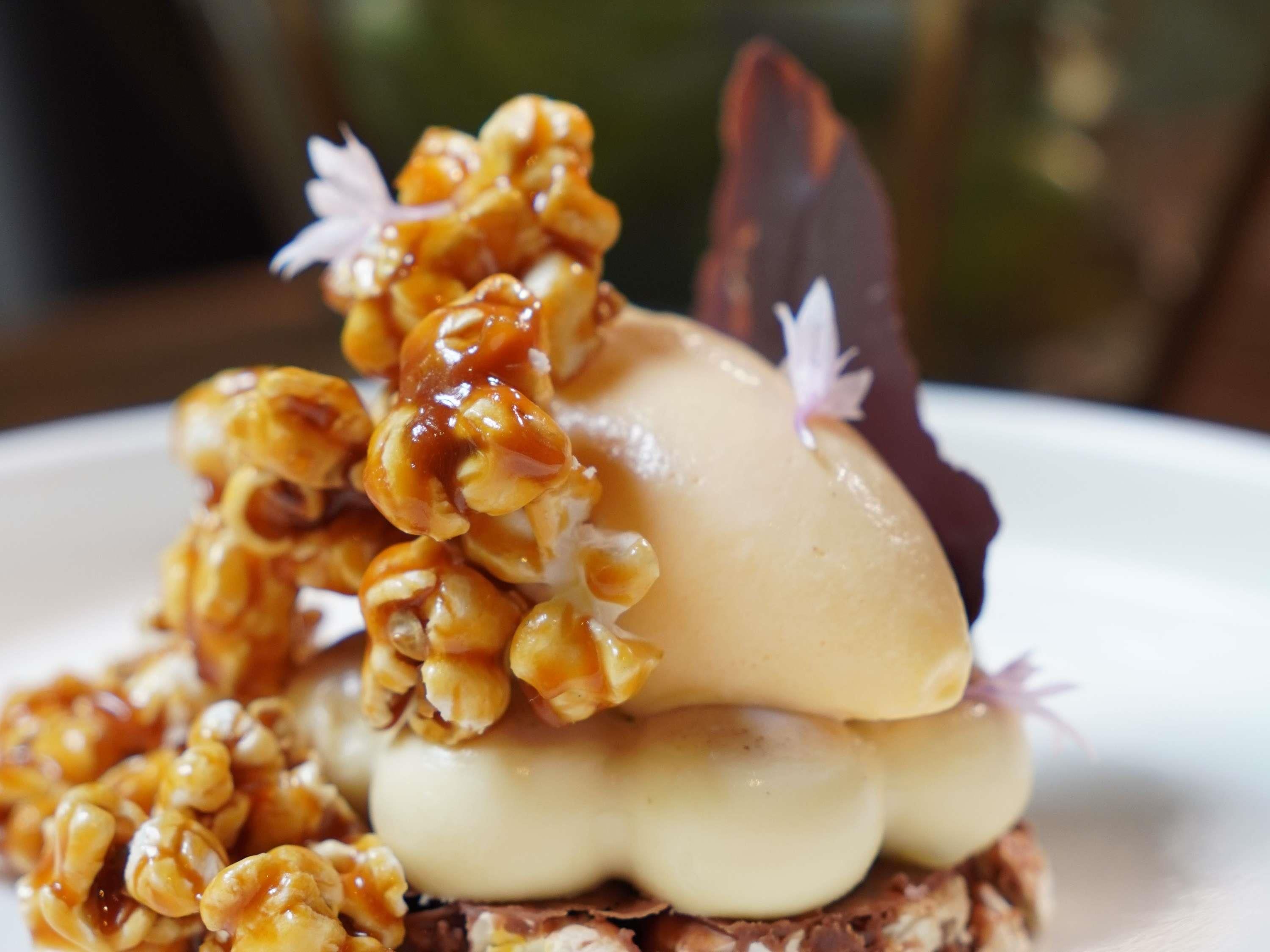 A dessert with walnuts and a chocolate piece on a plate.