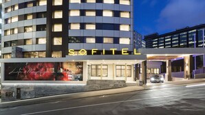 A modern hotel with a prominent 'SOFITEL' sign, large windows, and a well-lit entrance. - Sofitel Wellington (Wellington)