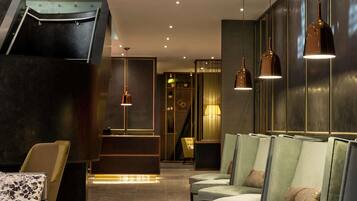 Eine moderne Lobby mit Empfangstresen, Sitzgelegenheiten und einer Treppe.