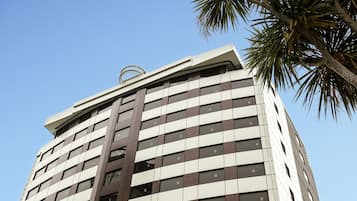 A high-rise hotel with a modern design, featuring a grid of windows and a prominent vertical structure.