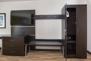 A modern bedroom with a built-in desk, a flat-screen TV, and a wardrobe. - Holiday Inn Express and Suites Lincoln I - 80 by IHG (Lincoln)