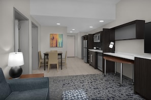 Una cocina moderna con gabinetes oscuros, una encimera blanca y una zona de comedor con mesa y sillas.