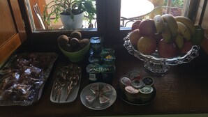 A kitchen counter with food items, a potted plant, and a window view.