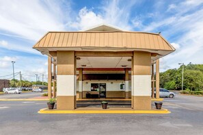 A standalone building with a flat roof, a single entrance, and a parking lot in front. - Tampa Inn Fairgrounds (Tampa)