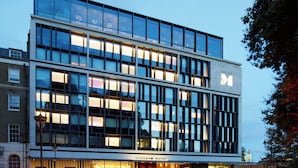 A modern hotel building with a glass facade, multiple floors, and a prominent 'CitizenM' sign. - citizenM Tower of London (London)