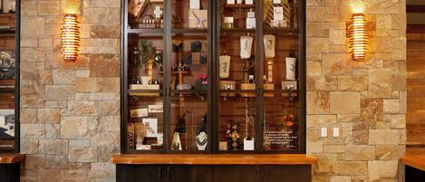 A stone wall with a glass display case containing various items.