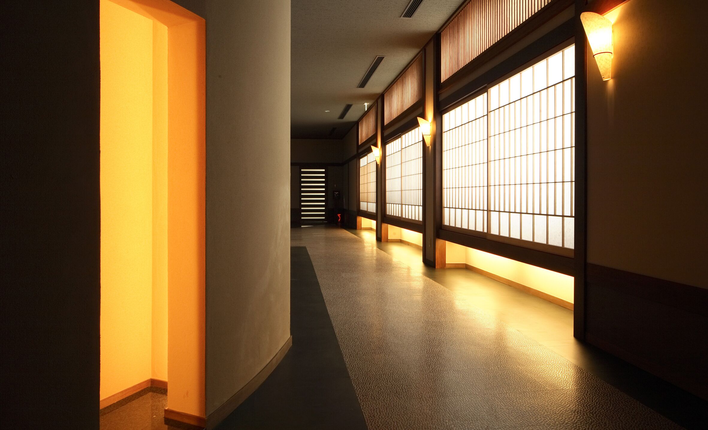 A corridor with traditional sliding doors and warm lighting.