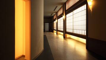 A corridor with traditional sliding doors and warm lighting.