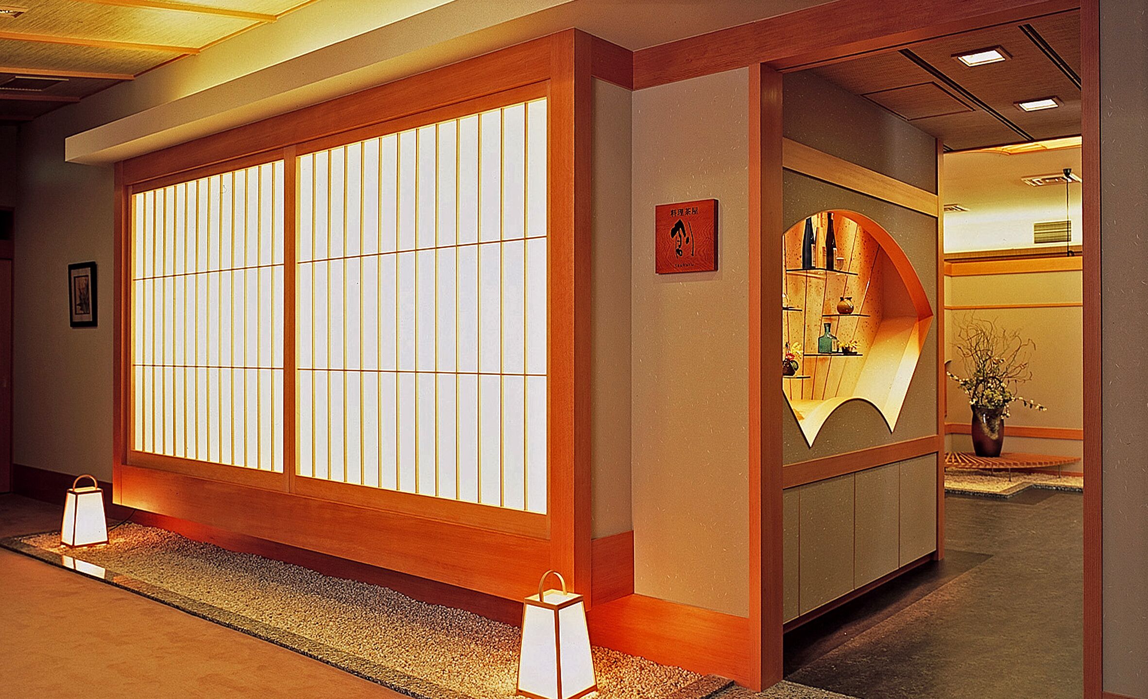 A traditional Japanese-style interior with sliding doors, a reception desk, and a small reception area.