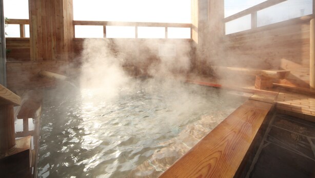 A steam room with wooden benches and a large window.